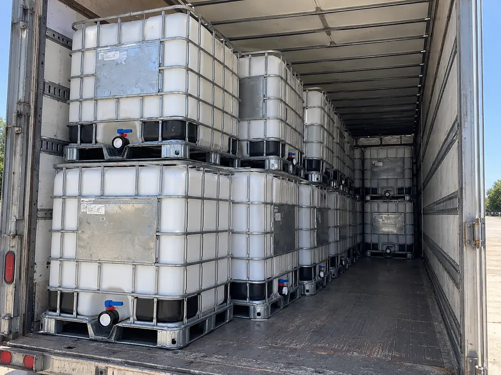 IBC totes loaded two tiers deep inside a dry van trailer
